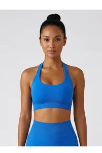 Detail shot of a blue halter U-neck sports bra with padded design for fitness and yoga.