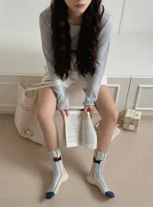 Cute Korean style women mid-calf socks featuring adorable black cat cartoon embroidery and blue white stripes.