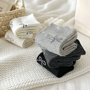 Korean style women mid-calf socks featuring cute bow embroidery in white grey and black colors.
