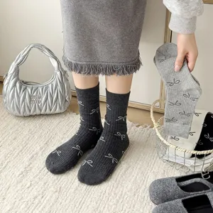 Grey ribbed mid-calf socks featuring cute white bow patterns, soft cotton blend everyday wear.