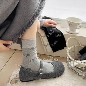Grey bow mid-calf socks detail shot, soft cotton knit material with cute bow patterns for women.
