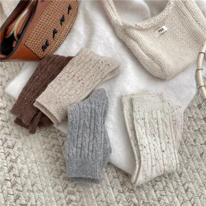 Thickened warm flecked cable knit wool mid-tube socks for women, cozy winter footwear.