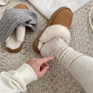 Thick wool blend cable knit winter socks with cozy fluffy slippers for warm daily wear.