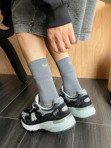Grey cotton crew socks for men featuring yellow embroidery, comfortable and breathable wear.