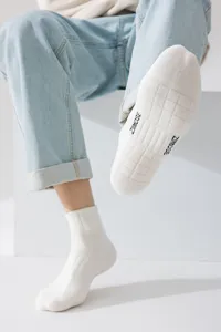 Men's white athletic crew socks featuring stylish letter print on sole, breathable cotton.