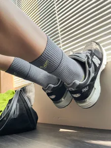 Men's grey ribbed crew socks with yellow embroidered letter design for comfortable wear.