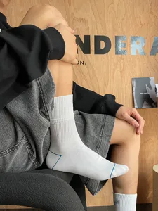 Men's white crew sports socks with ribbed cuff and blue accent lines for daily wear