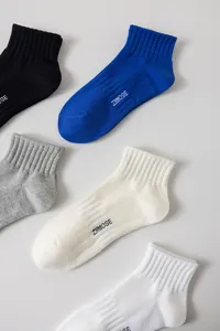 Detail view of men's breathable cotton short socks featuring stylish letter prints and neat rib-knit cuffs.