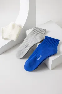 Detail shot of men's breathable cotton short socks in white grey and blue with letter print.