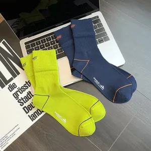Detailed shot of mid-calf cotton athletic socks with ribbed cuffs and unique embroidery.