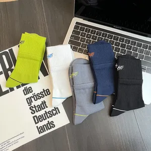 Detailed view of men's ribbed mid-calf crew socks in multiple colors with embroidery.