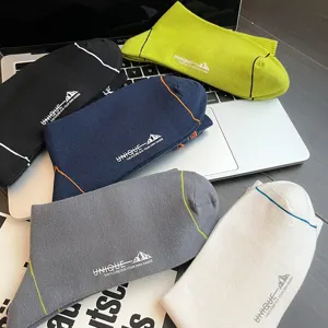 Men's mid-calf cotton sports socks with letter embroidery and double ribbed cuff, breathable.