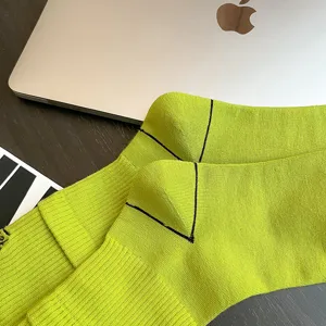 Neon green fashion socks detail view, featuring ribbed cuff and reinforced heel design for men.