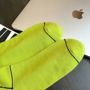 Neon green mid-calf sports socks with black stripes, breathable and comfortable cotton fabric.