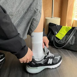 Men's mid-tube cotton sports socks with stylish letter embroidery and comfortable double rib cuffs.