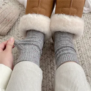 Cozy grey speckled cable knit wool socks detail shot, soft winter mid-calf warm hosiery.