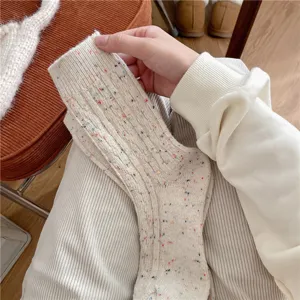 Thickened women winter warm wool blend mid-tube socks with cozy colorful flecked knit design.
