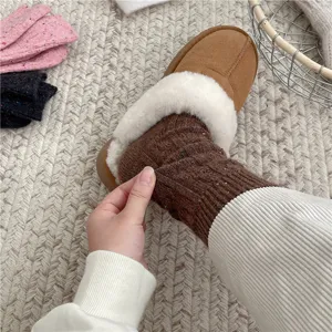 Closeup of thick cable knit wool socks for women, cozy winter thermal textured mid tube sock.