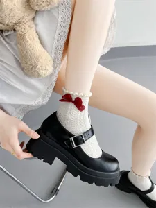 Japanese JK style white lace mid-tube socks featuring red bow detail and chunky shoes.