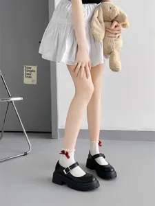 Japanese JK style white lace socks with cute red bow details and platform Mary Jane shoes.