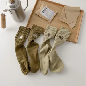 Green and khaki cotton camping socks featuring embroidered mountain designs, mid-calf length.