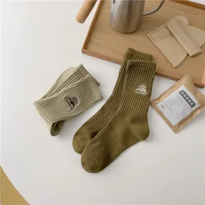 Outdoor camping style mid-calf socks for men and women, featuring embroidered mountain design.