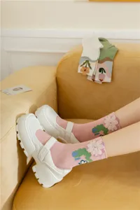 Cute Japanese style plush flower crew socks for women paired with chic white platform shoes.