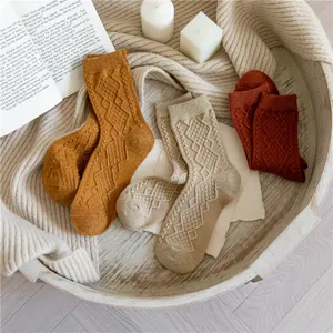 Detailed view of women knit diamond pattern wool blend socks in cozy retro style.