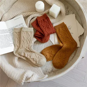 Cozy wool blend diamond knit socks scene, warm autumn winter retro mid tube socks detail view.
