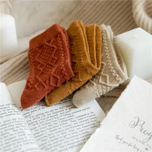 Detail view of women's wool blend diamond knit vintage warm thick mid-tube winter socks.