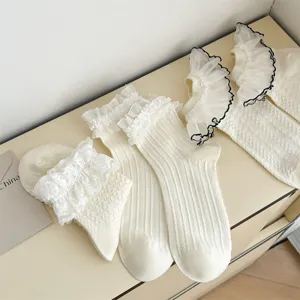 Detail shot of Japanese JK style white lace frill socks, sweet Lolita mid-tube fashion socks.