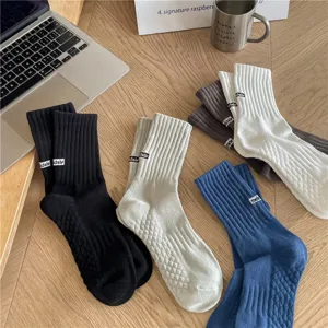 Detailed view of mens ribbed crew socks featuring stylish letter embroidery and comfortable fit.