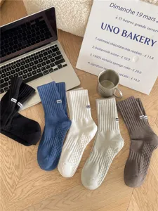 Men's ribbed crew socks with anti-slip grip sole and stylish embroidery lettering, comfortable.