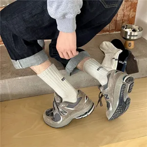 Men's rib knit mid-tube socks with letter embroidery. Versatile casual athletic wear.