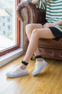 Detailed shot of breathable lace mesh socks paired with stylish white canvas sneakers indoors.