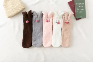 Cozy thick fuzzy socks for women with cute bunny ears, warm coral fleece winter sleep socks.