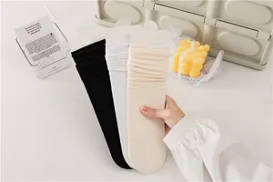 Vue détaillée de chaussettes longues unies en noir, blanc et beige pour un usage quotidien.