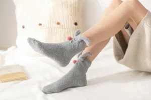 Cozy coral fleece fuzzy socks detail showing cute 3d rabbit ears and soft warm texture.