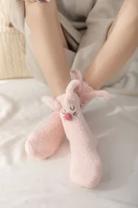 Cozy pink fluffy plush socks with cute 3d rabbit ears, soft coral fleece winter sleep floor socks detail.