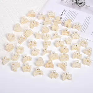 Detailed macro view of various small decorative pearl hair claw clips in elegant shapes