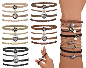 Detail showing variety of elastic hair ties with flower and heart charms.