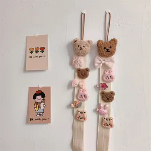 Wall-mounted hair bow organizer strap featuring cute plush bear and rabbit clips.