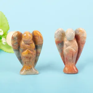 Close-up of hand-carved natural crystal angel figurines with unique stone textures.
