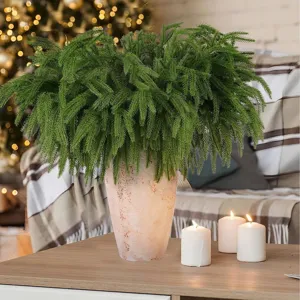 Detailed view of lifelike Norfolk pine branches in a rustic vase for Christmas decor