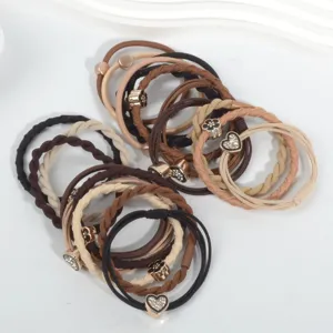 Macro view of 20 assorted earth-toned high elasticity hair ties with decorative charms