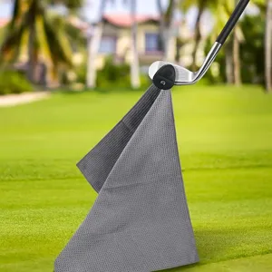 Detailed view of gray waffle microfiber golf towel attached magnetically to a club