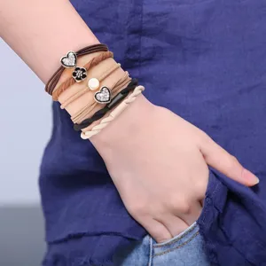 Macro view of decorative elastic hair ties with heart and flower charms on wrist