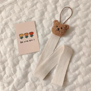 Close-up view of a cute bear nursery wall strap for hair accessory storage and decor.