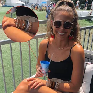 Detail view of a model wearing a set of elastic hair ties and bracelets outdoors