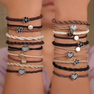 Macro view of 20pcs high-elasticity hair bands with heart and flower charms on arms.